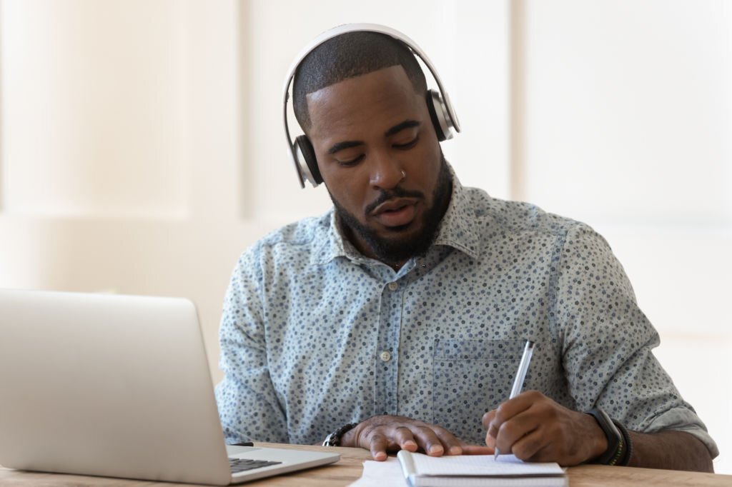 A young man looking through online job sites to find remote work