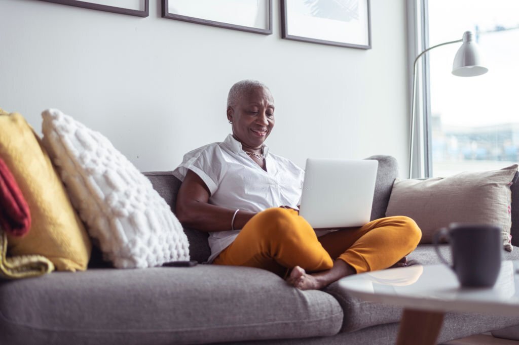 A black senior woman working online