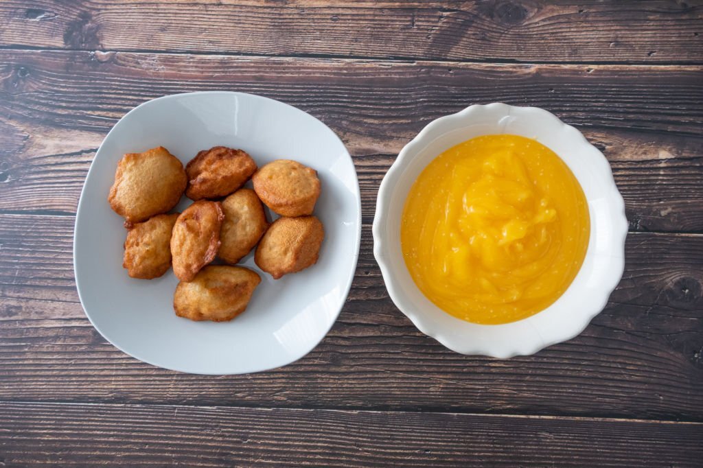 Akara on a plate with corn pudding as the side dish