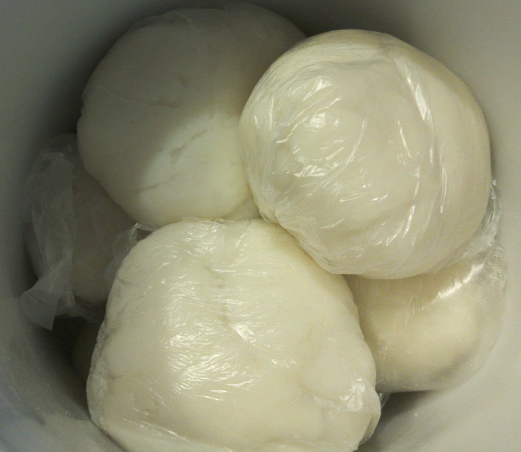 Pounded yam wrapped with a transparent plastic and in a warmer to keep it warm