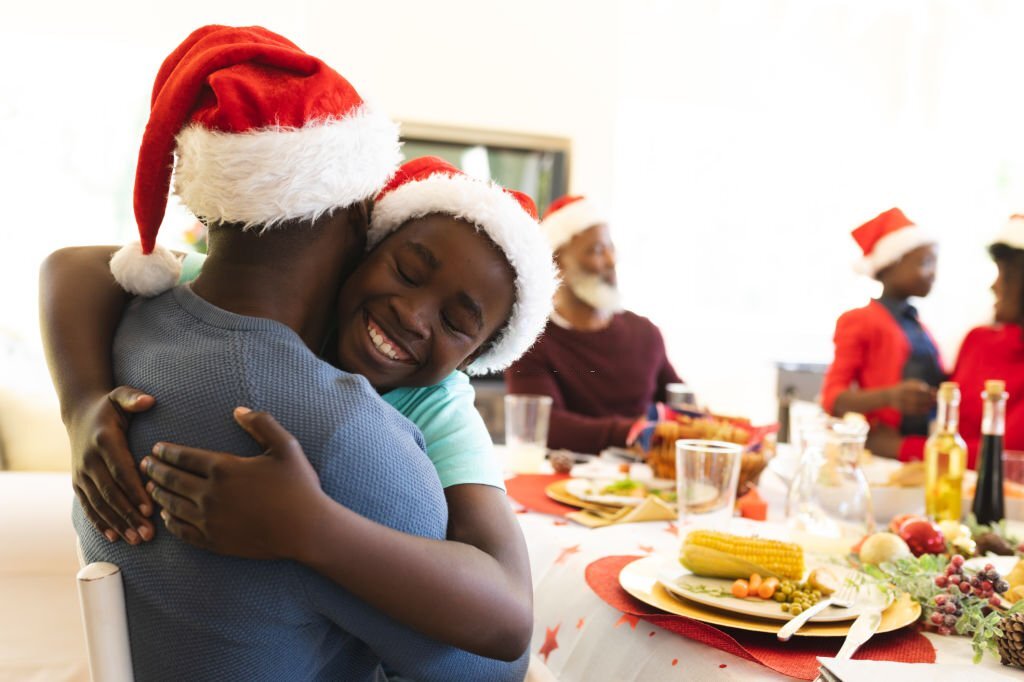 A Man and son hugging each other in the spirit of christmas greetings - BEST CHRISTMAS GREETINGS  FOR CARDS AND MESSAGES 2022/2023